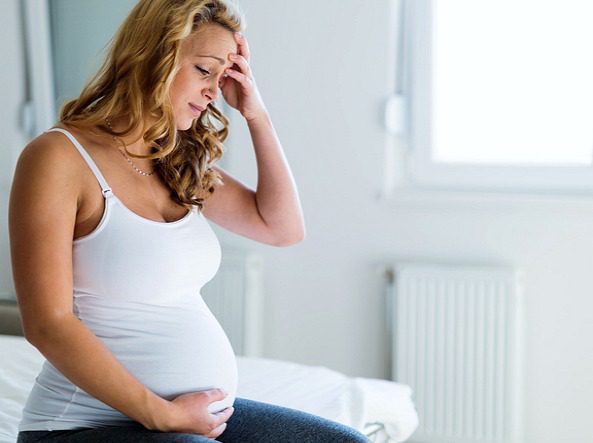 A pregnant woman consider adoption for her child through Lifetime Adoption in Arkansas